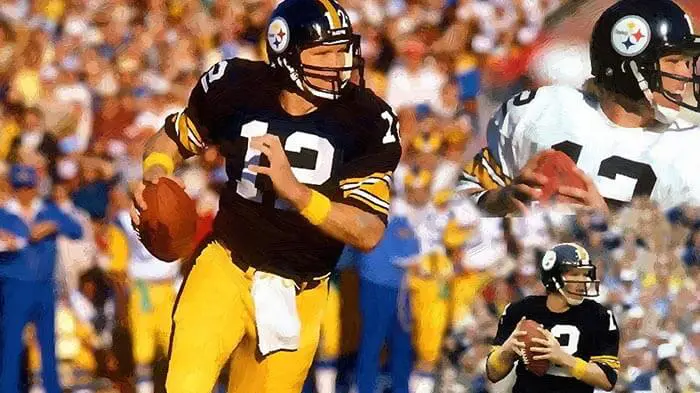 Football player in black and yellow uniform running with the ball.
