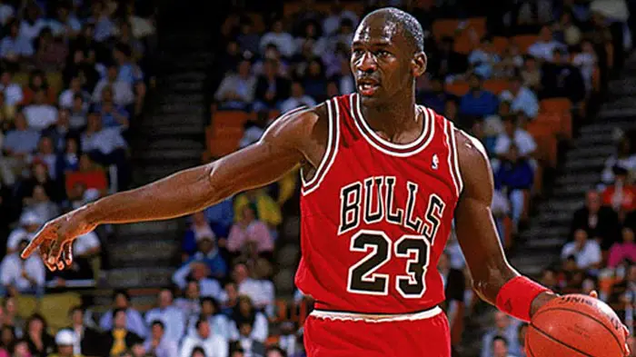 Michael Jordan in a Bulls jersey during a basketball game.
