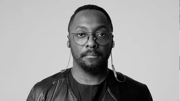 Black and white portrait of a man with glasses and a leather jacket.