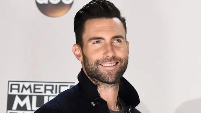 Portrait of a smiling man with dark hair and beard.
