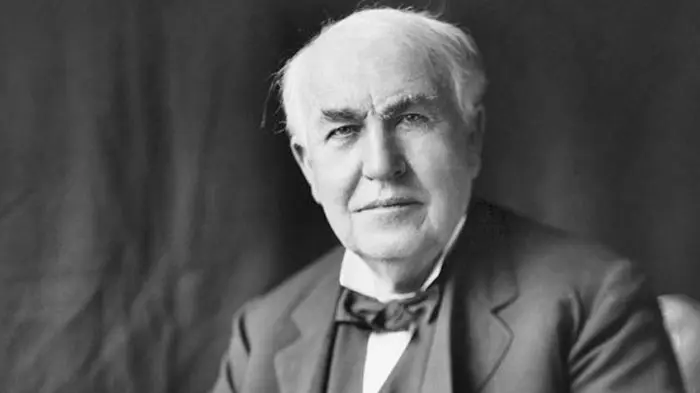 Black and white portrait of Thomas Edison in a suit and bow tie.