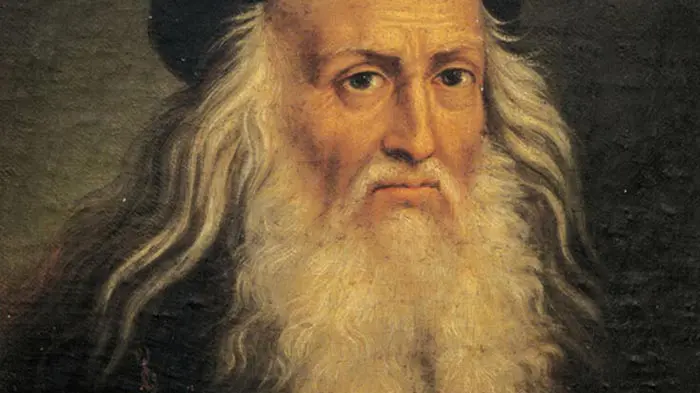 Portrait of an elderly man with a long white beard and solemn expression.