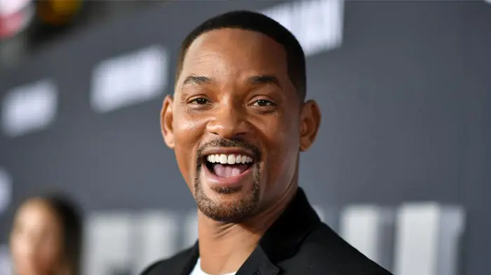 Smiling man with a neatly trimmed beard and short hair.