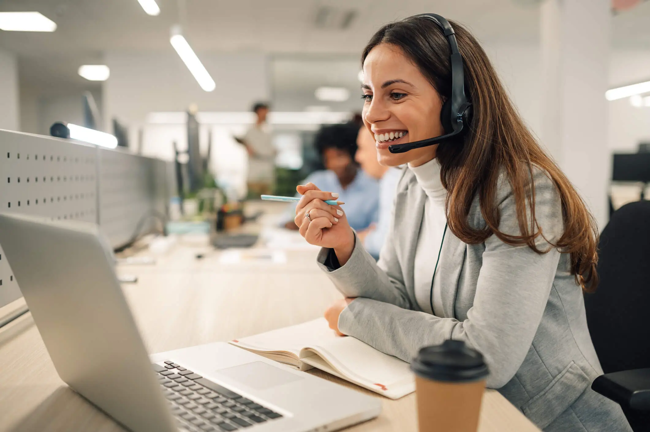 Customer service representative assisting a client with a headset.